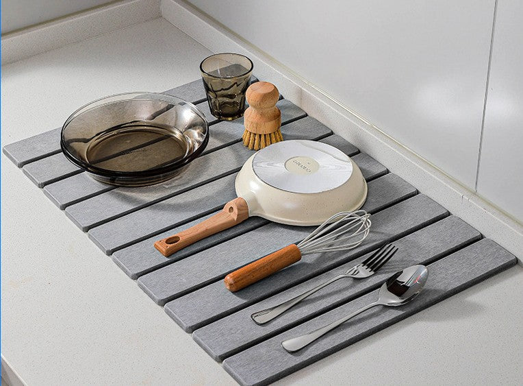 Neat Theory stone dish drying mat beside a kitchen sink